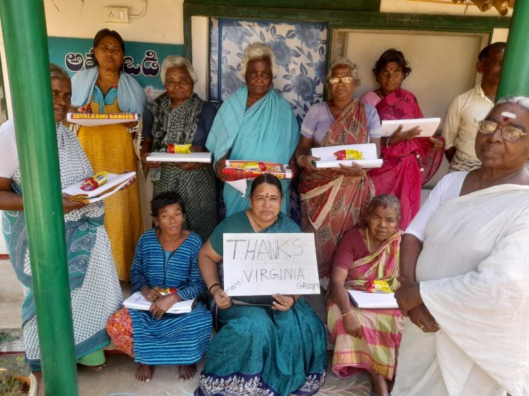 In India, working with a Groom Ventures employee and his family, we gave money to working families. The volunteer holding the sign is  Prudhvi's mother.